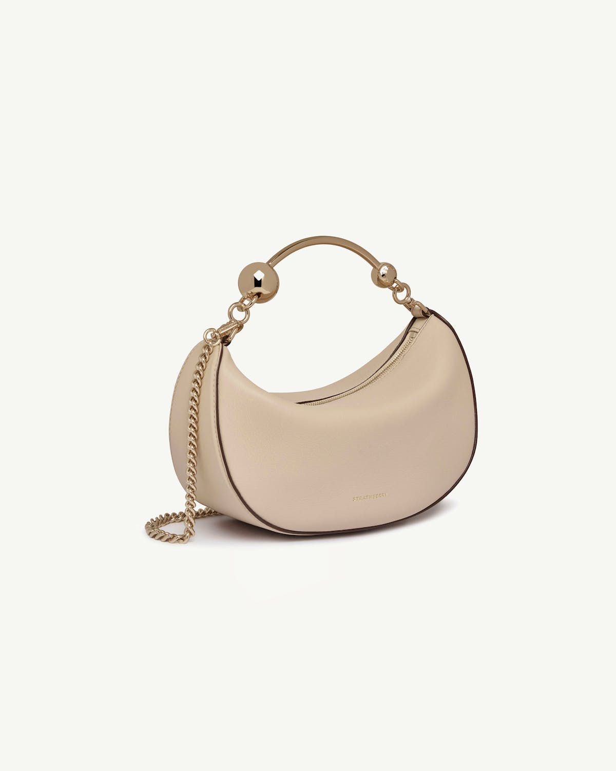 Strathberry Crescent Moon Mini bag in oat leather with gold chain and handle.