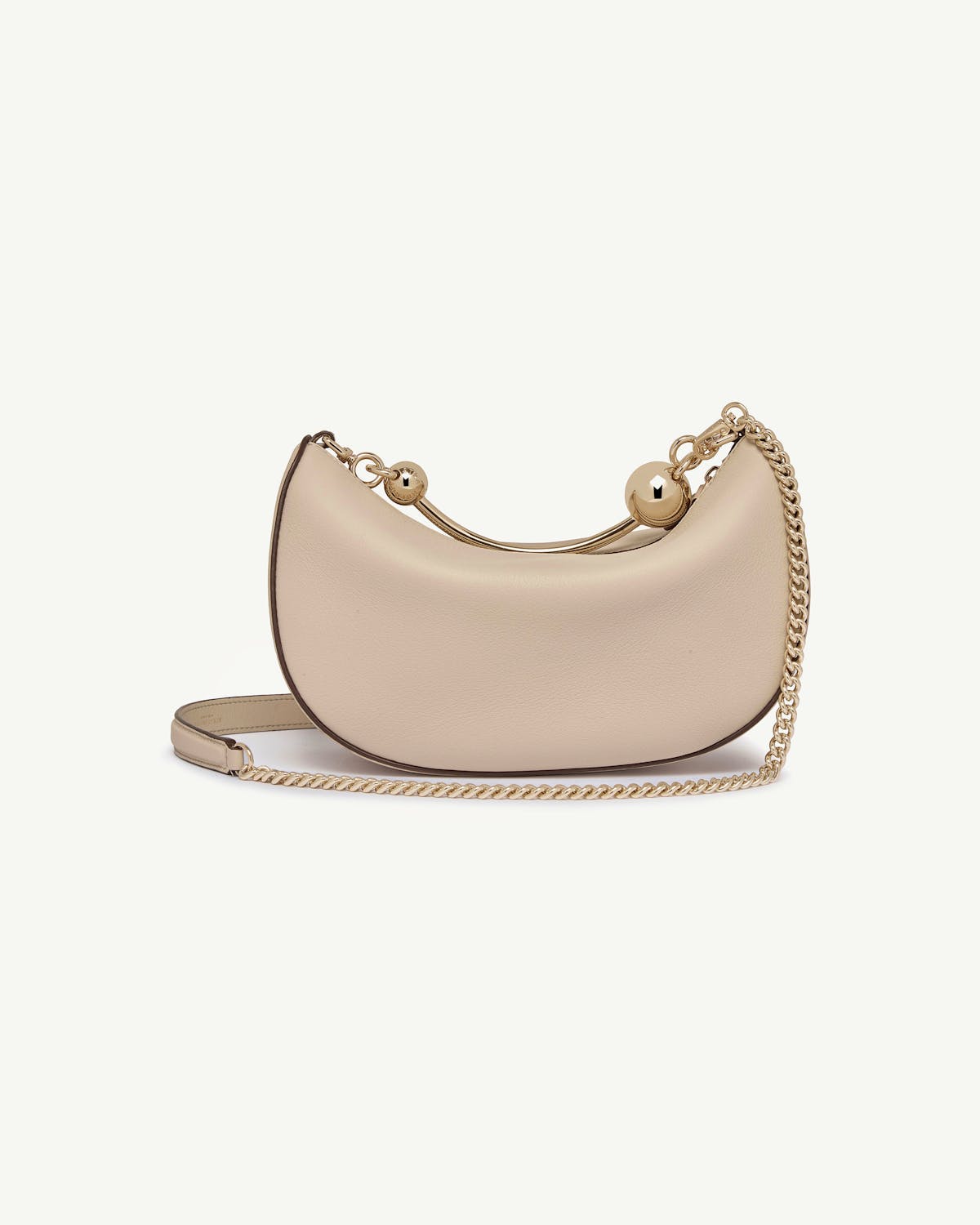 Crescent-shaped mini bag in oat leather with gold chain strap.