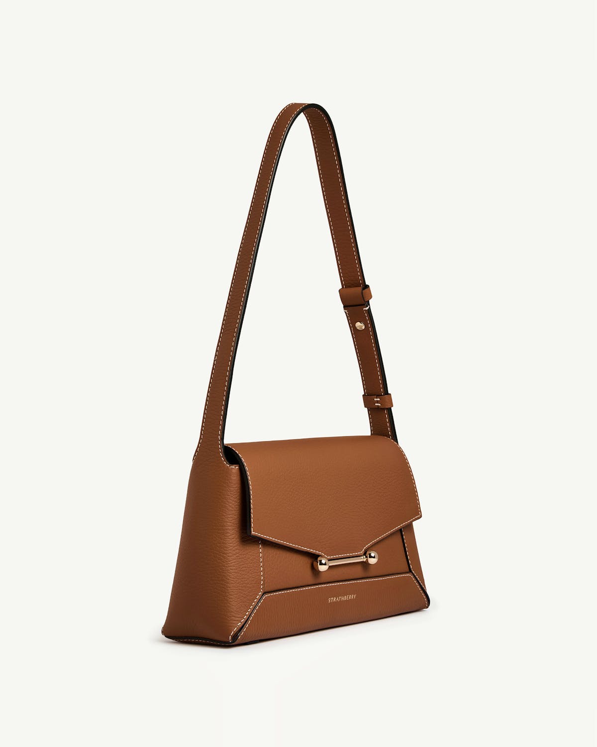 Tan Strathberry Mosaic shoulder bag with flap, gold bar fastening and white stitching.