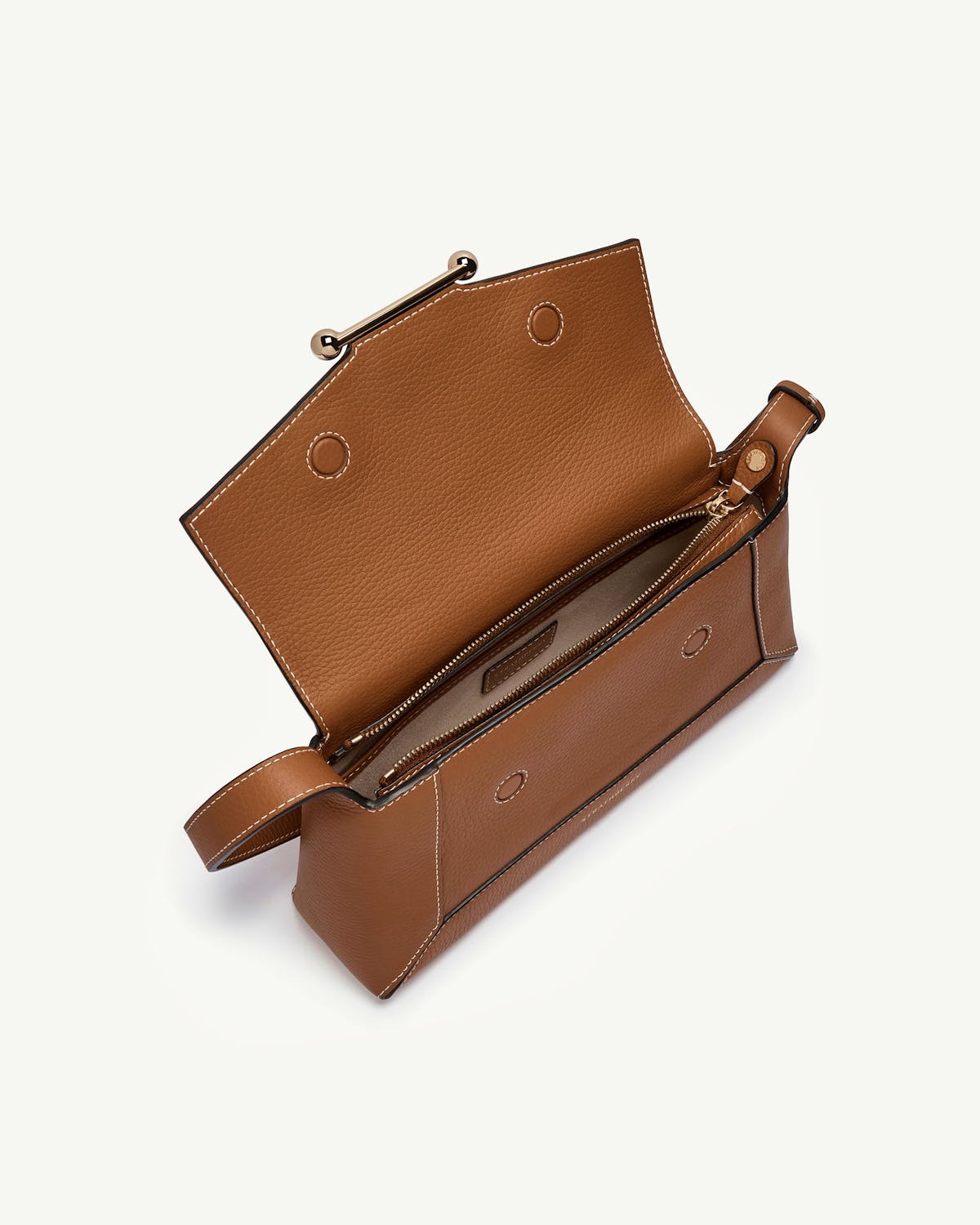 Tan leather shoulder bag with flap open and interior zip compartment visible