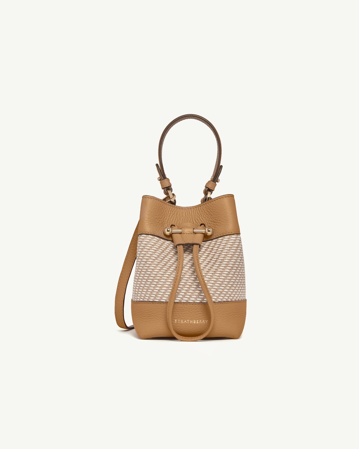 Strathberry Osette bucket bag in caramel leather with natural twill panels.