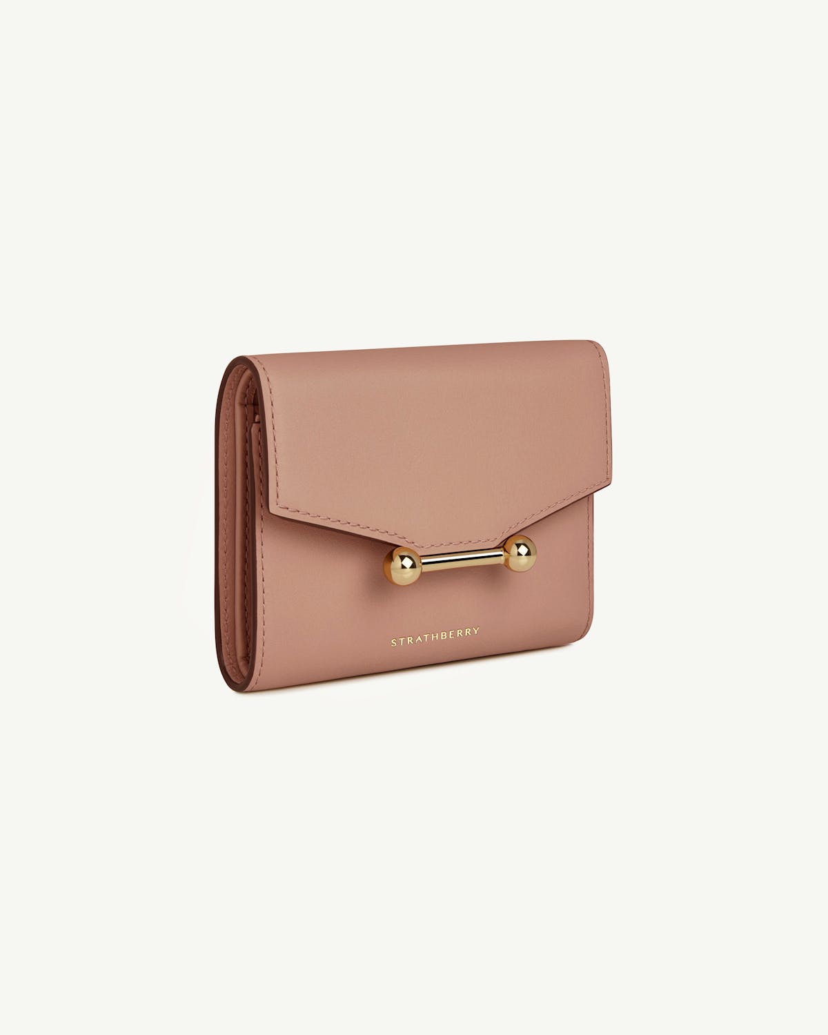 Rose trifold wallet with gold bar closure and Strathberry wordmark.