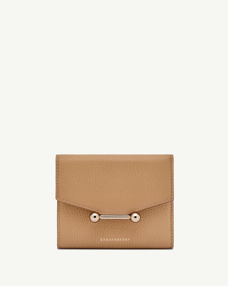 Strathberry mosaic trifold wallet in caramel grained leather with bar fastening.