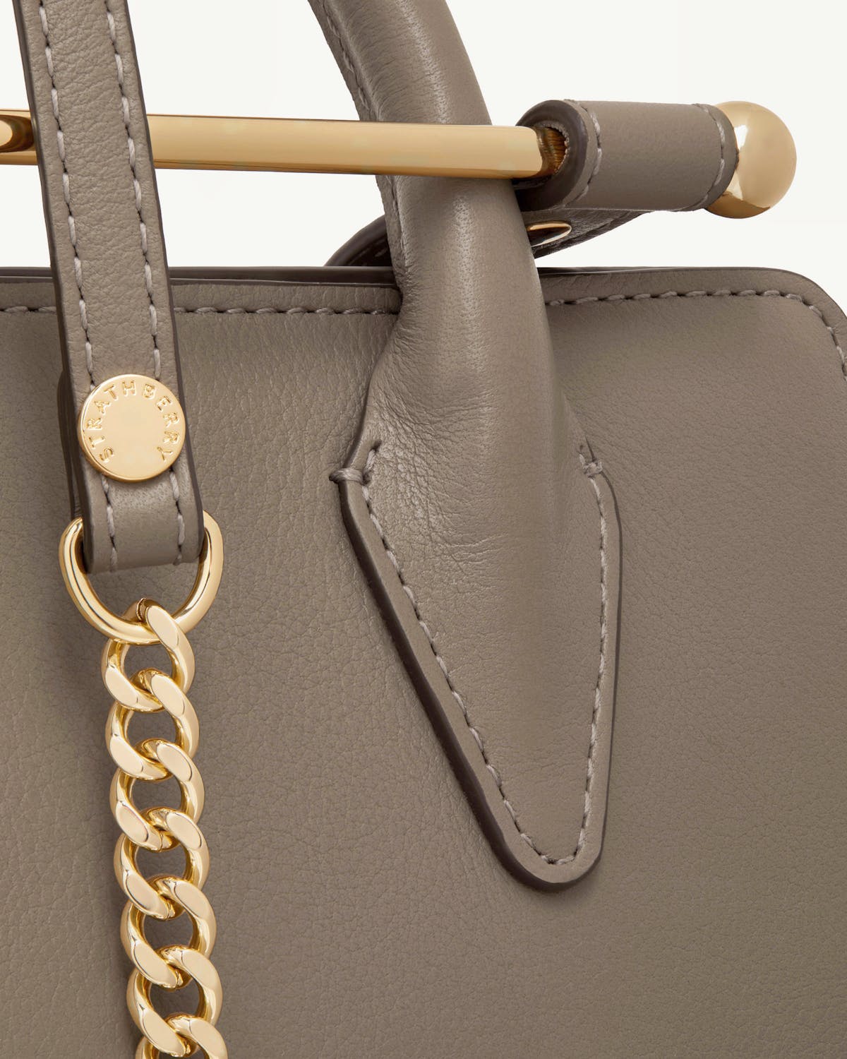 Taupe leather mini tote handle, gold chain and Strathberry engraved hardware.