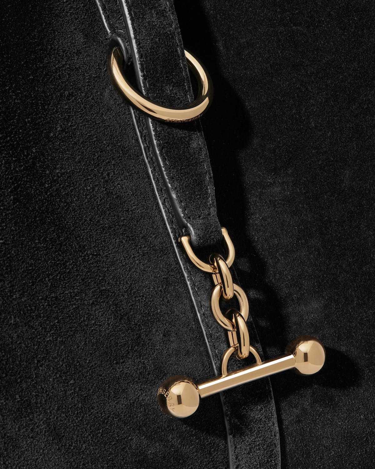 Detail of black suede Kite Hobo Maxi showing gold T-bar and chain.