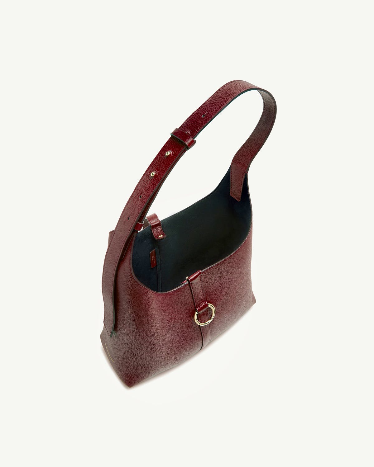 Oxblood leather kite hobo bag with single shoulder strap and gold ring.