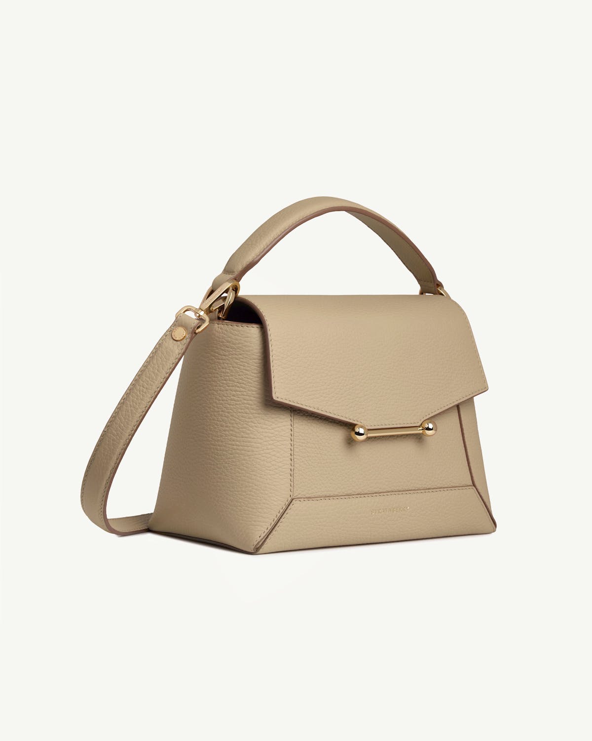 Strathberry sand leather mosaic bag with top handle, shoulder strap, and gold bar closure.