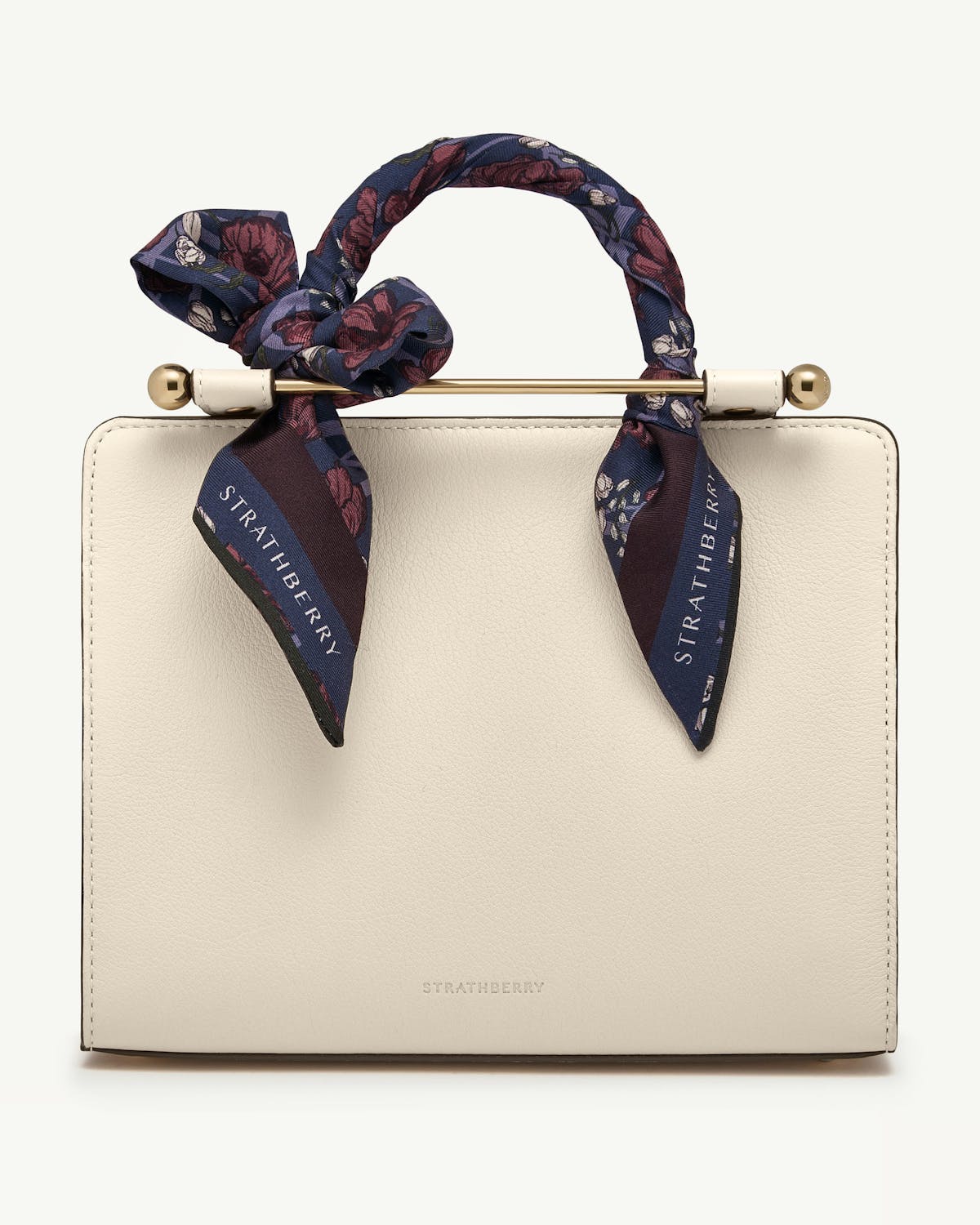Burgundy and navy floral silk skinny scarf tied to cream Strathberry bag handle.