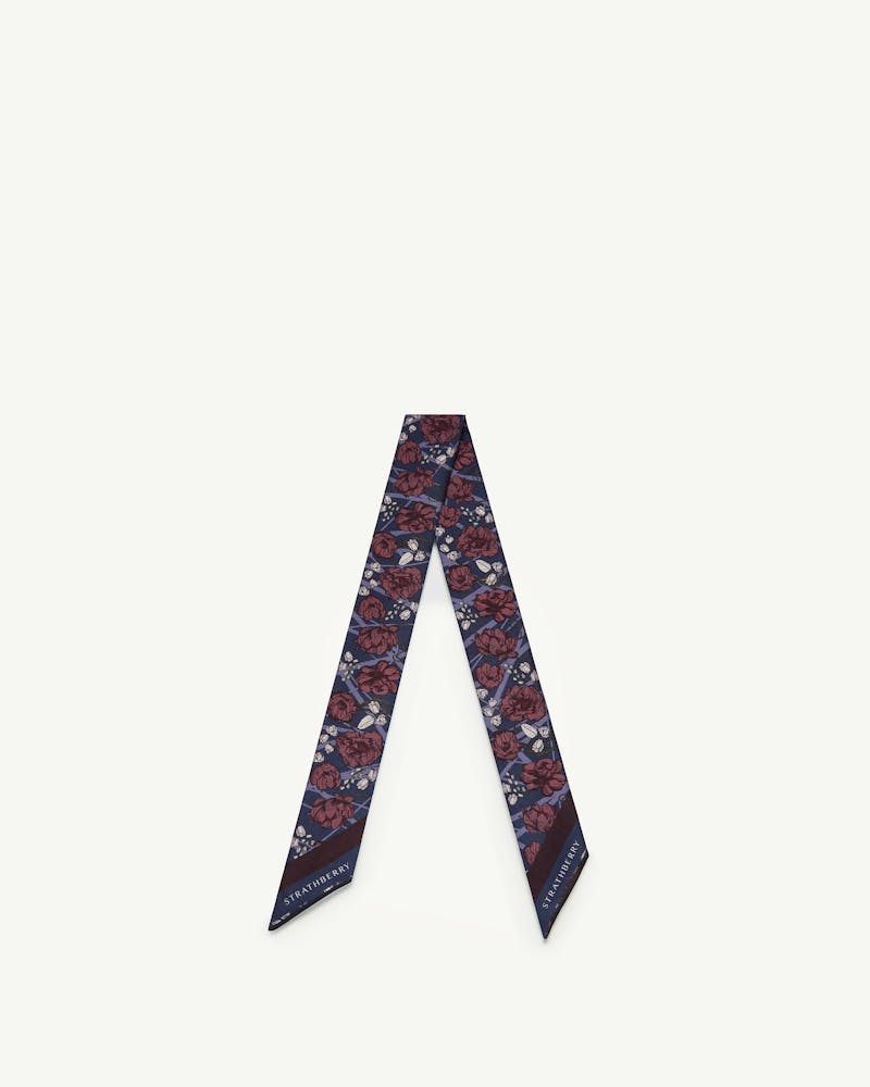 Navy silk skinny scarf with burgundy floral print and Strathberry logo.
