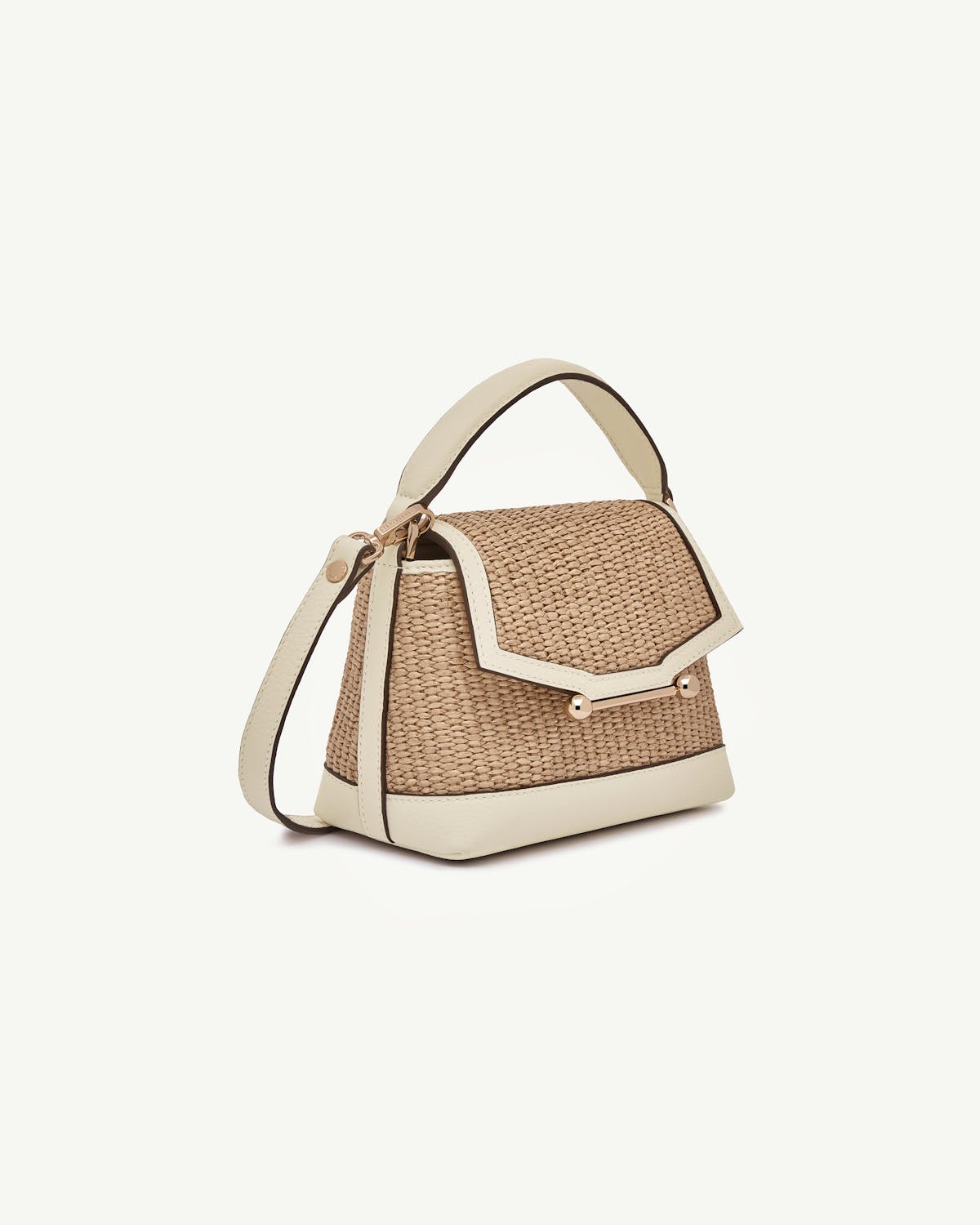 Small raffia top handle bag with vanilla leather trim and gold hardware.