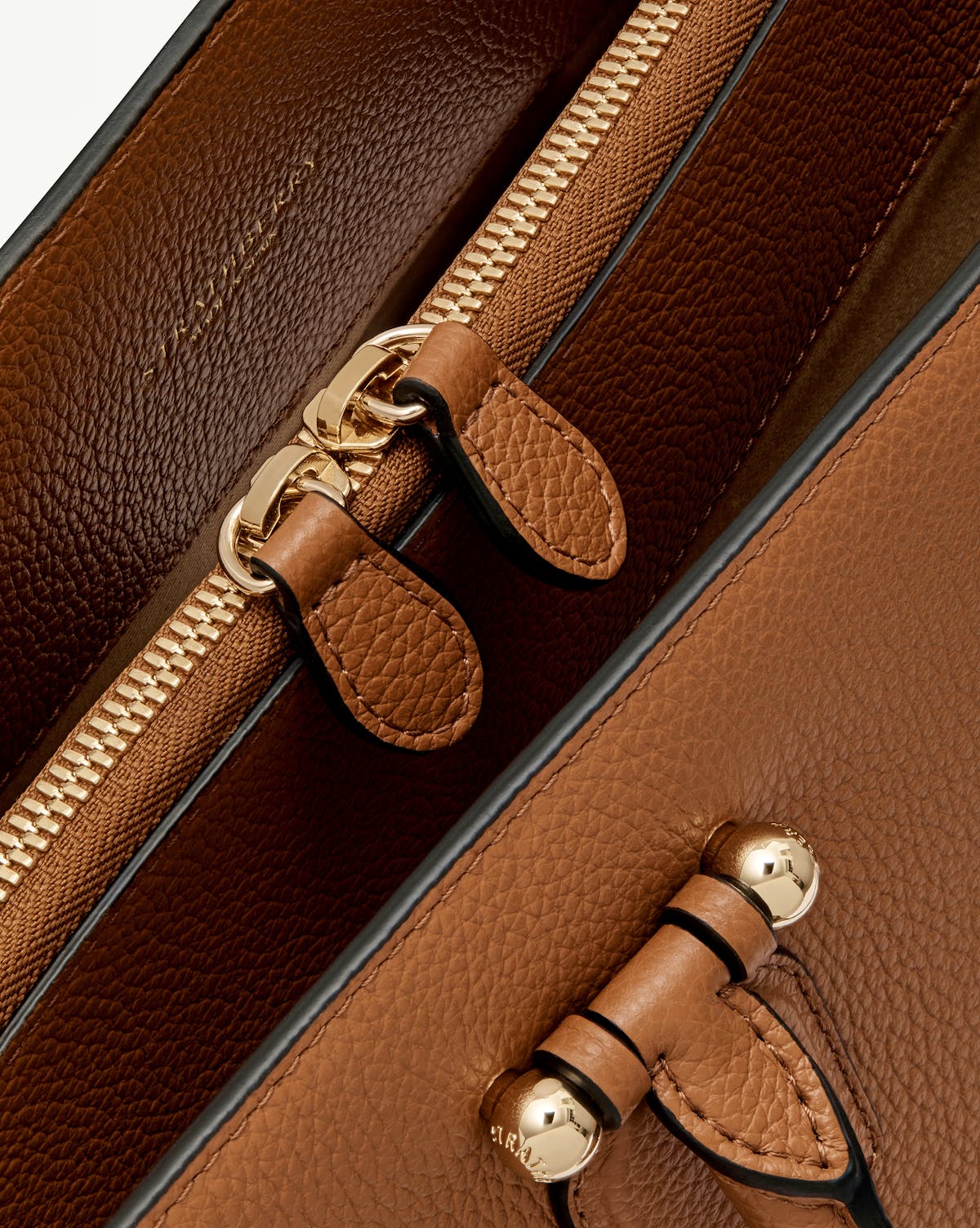 Tan leather bag interior zip, strap and gold Strathberry hardware.