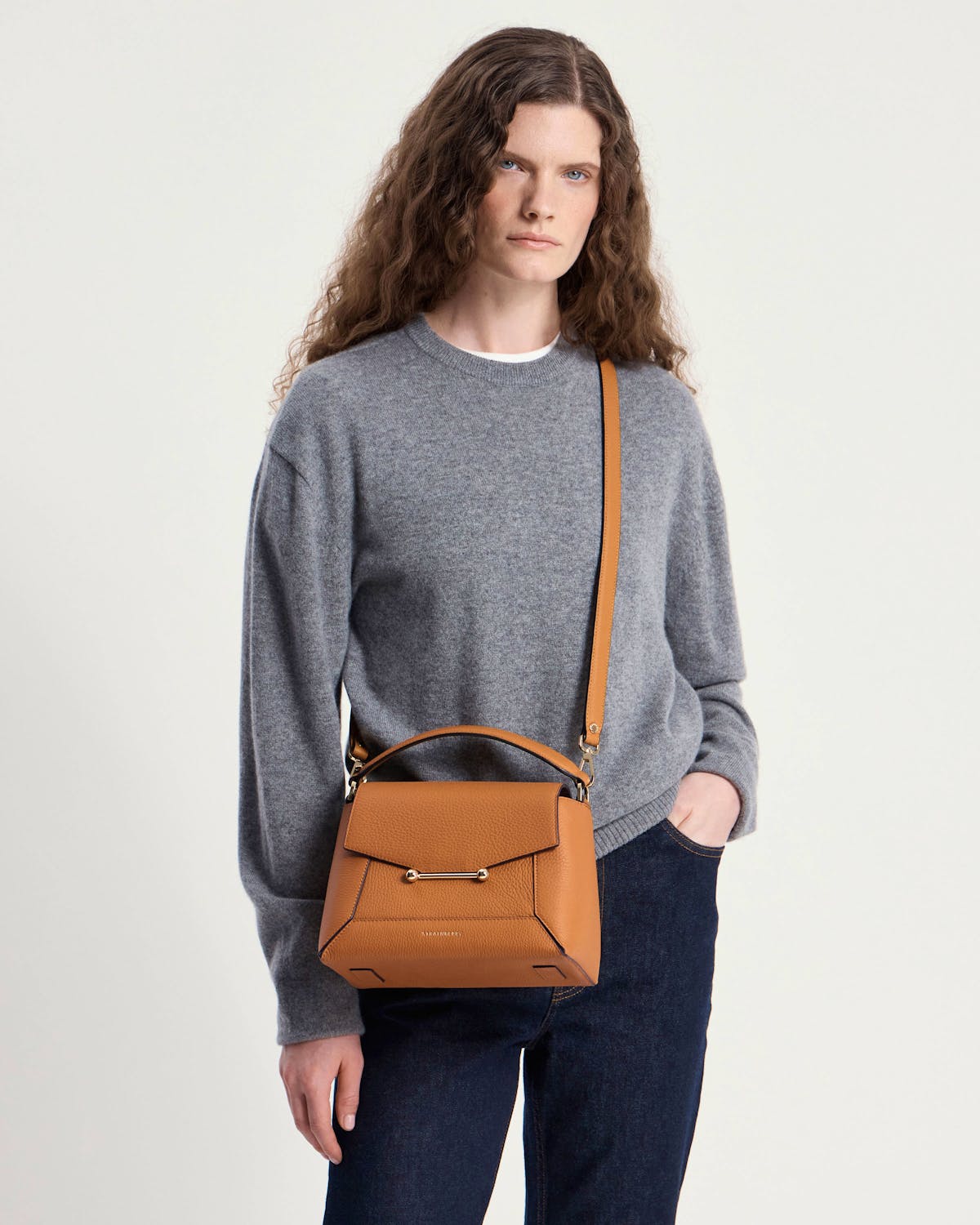 Model wearing grey sweater with honey mosaic bag, top handle and shoulder strap.