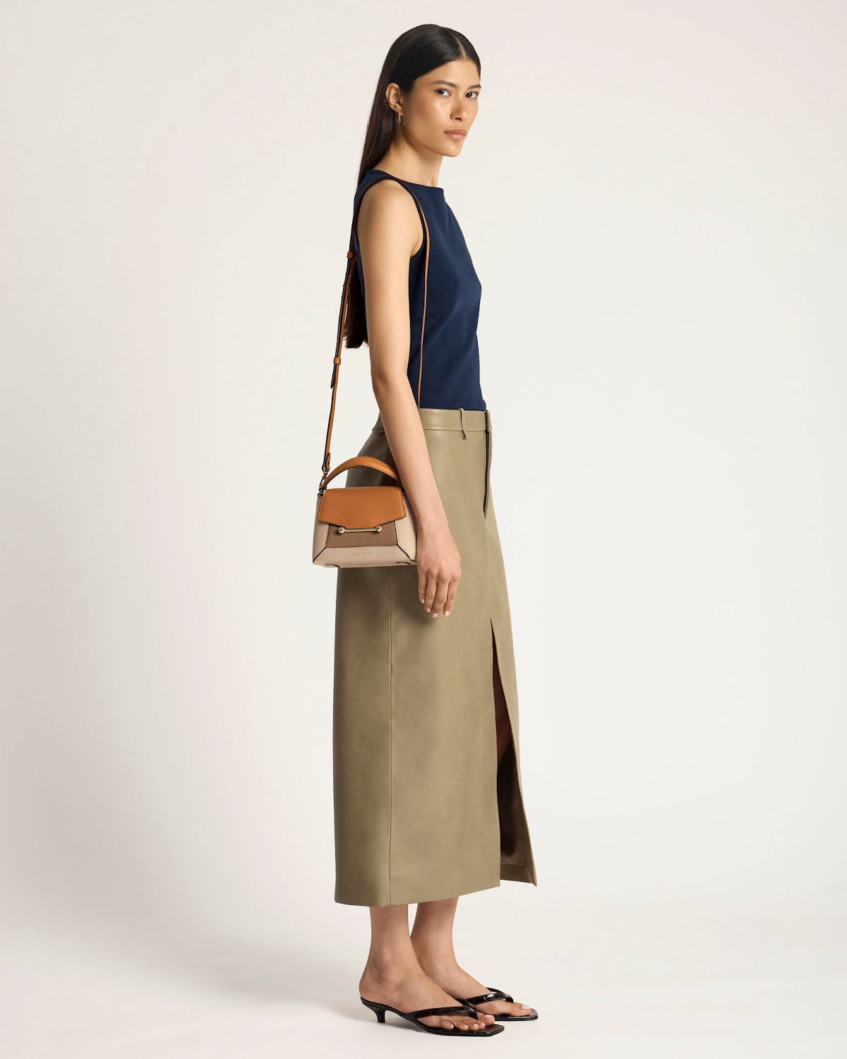 Model carrying a Mosaic Nano bag in oat, honey and clay tones.