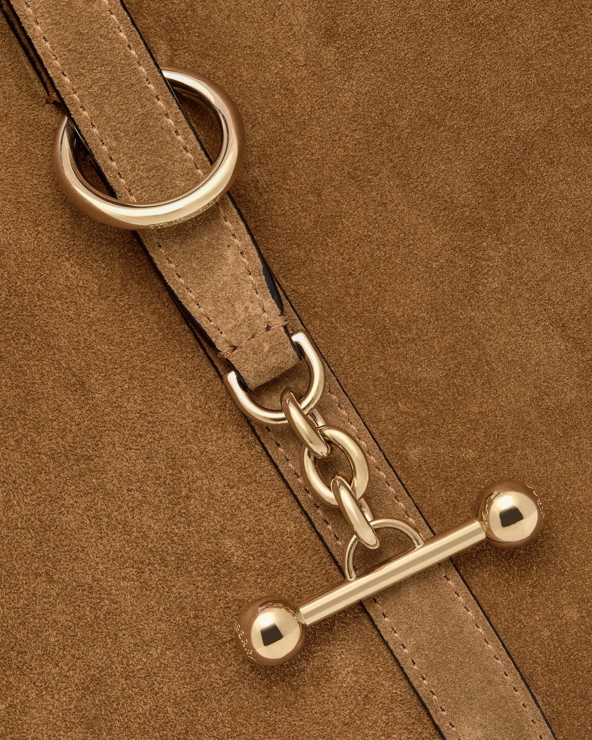 Toffee suede strap with gold chain links and toggle fastener hardware.