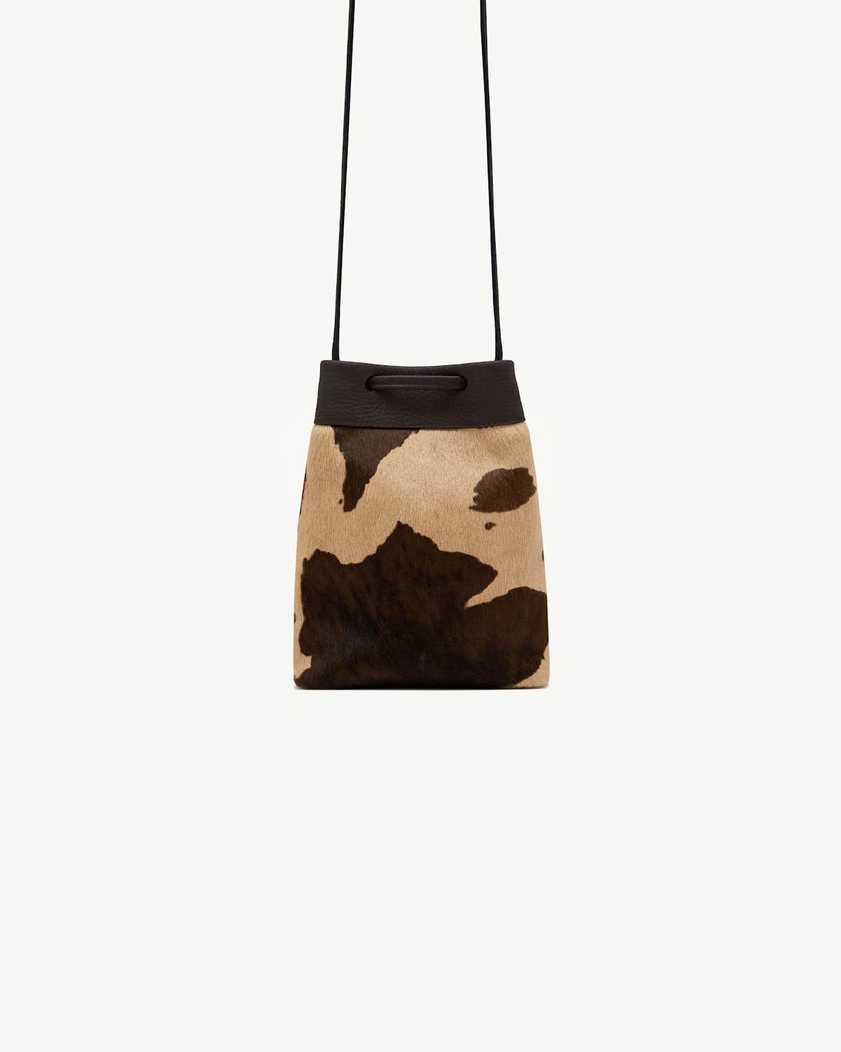 Sand and espresso spot-print midi pouch with dark leather trim and thin strap.