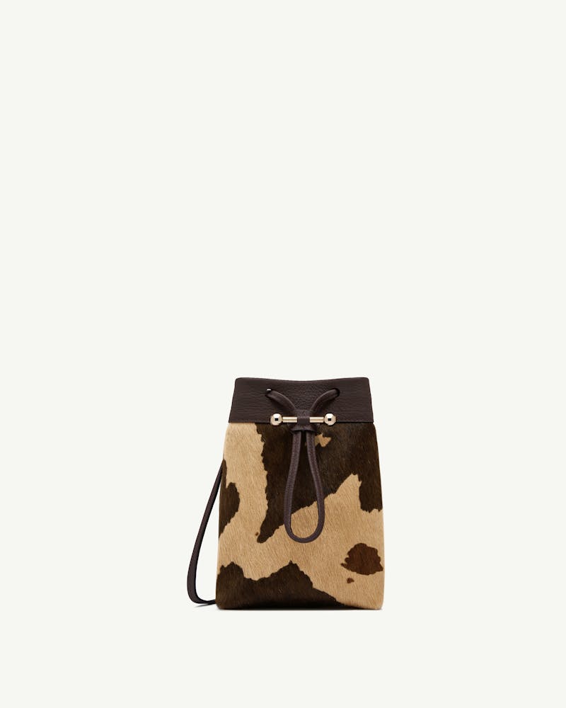 Sand and espresso spot-print midi pouch with dark leather trim, drawstring and gold bar.