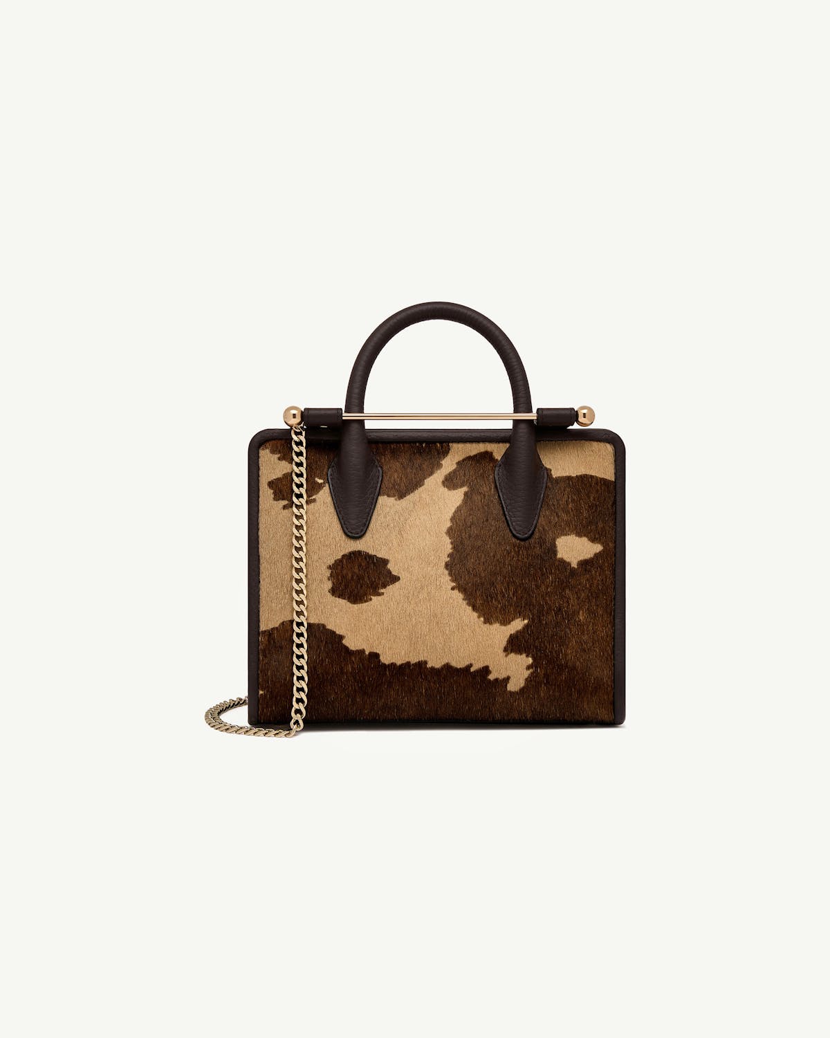 Mini tote with sand and espresso spot print, top handle and gold chain strap.
