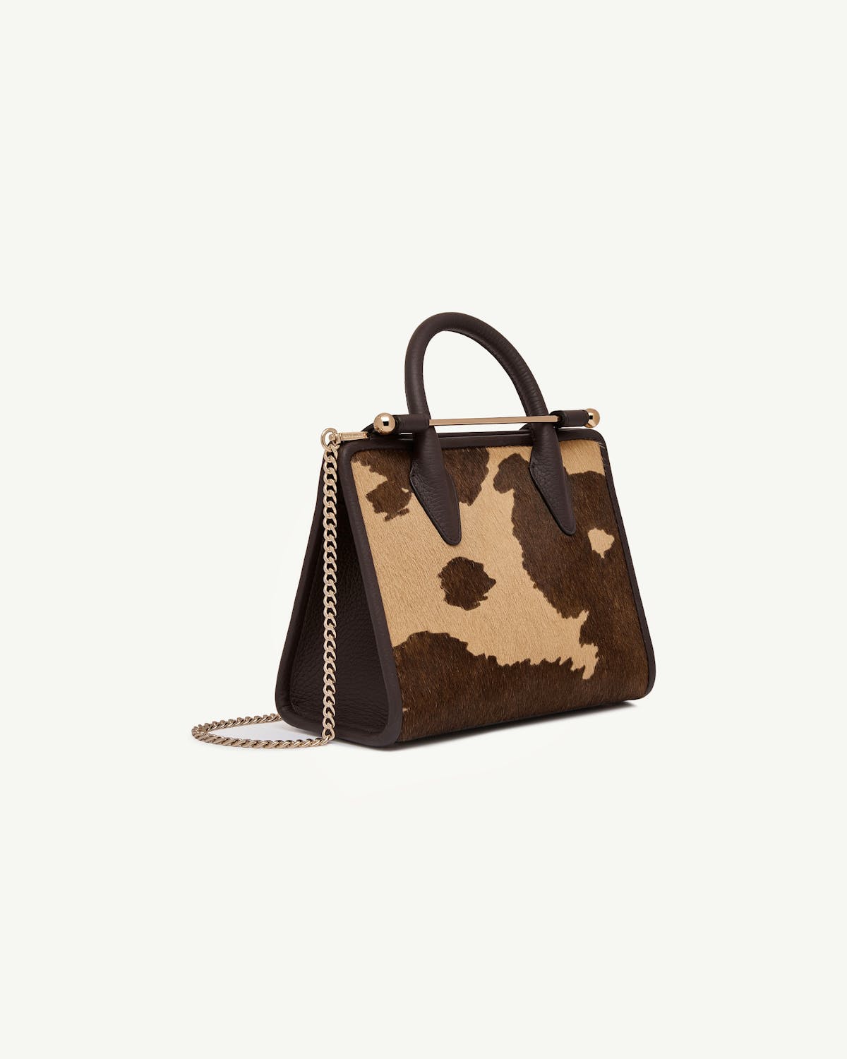 Mini tote with sand and espresso spot print, dark brown leather trim, gold chain strap.