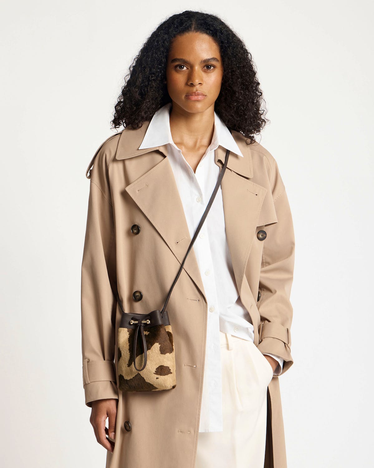 Sand and espresso spot midi pouch worn crossbody with beige trench coat