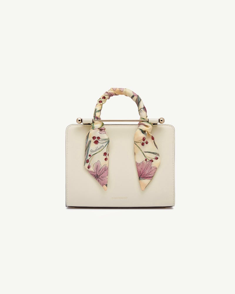 Butter yellow silk skinny scarf with berry flower print tied to Strathberry bag handle.