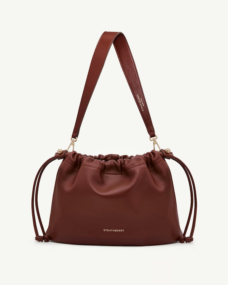Strathberry Charlotte midi drawstring bag in walnut leather with strap.