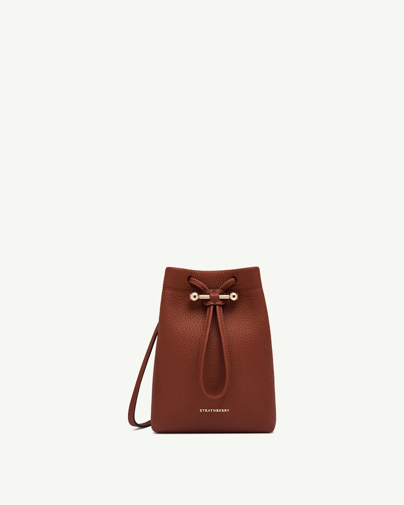 Walnut leather Osette Midi Pouch with drawstring top and Strathberry logo.