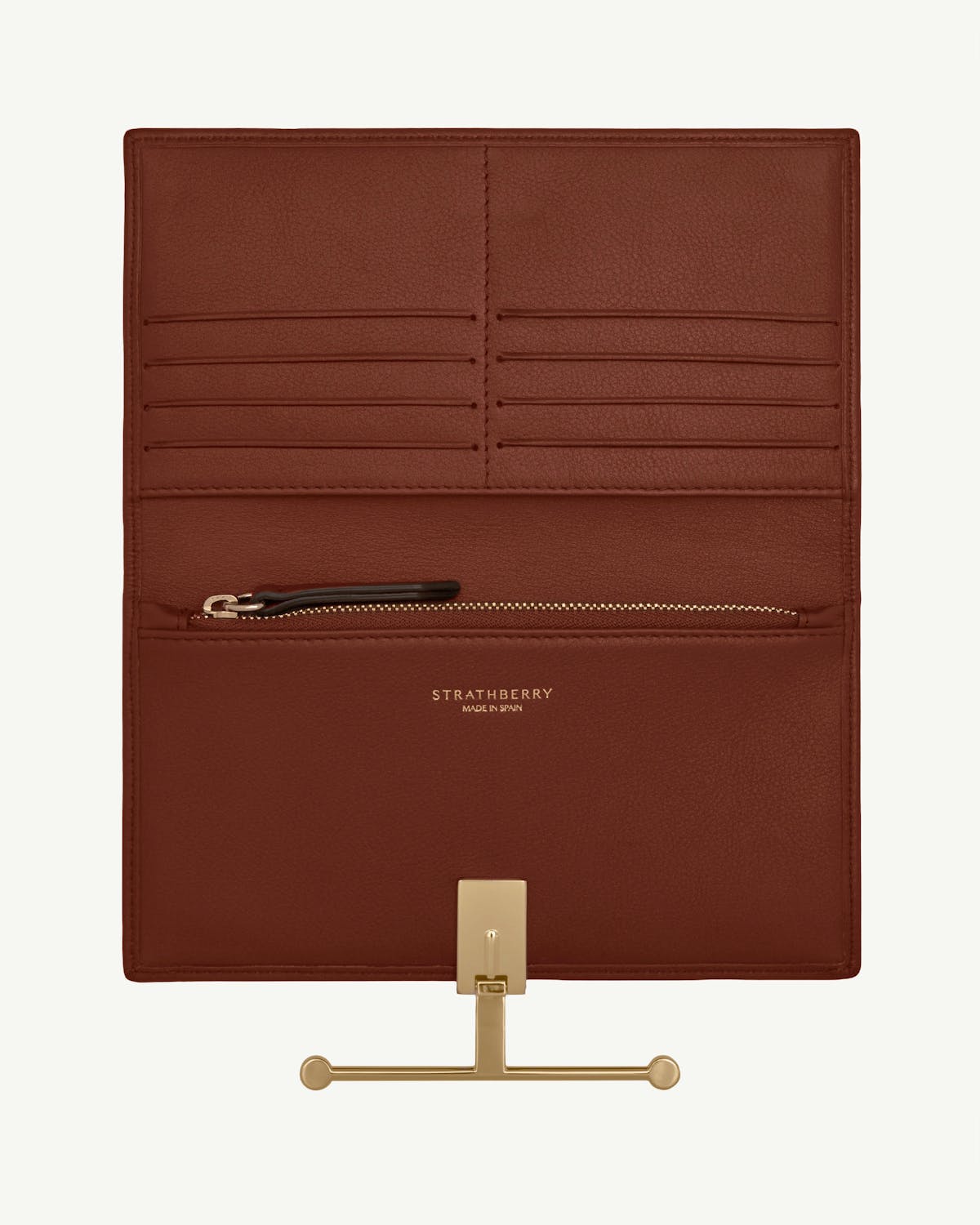 Strathberry walnut leather wallet interior with multiple card slots, zip pocket and gold hardware.