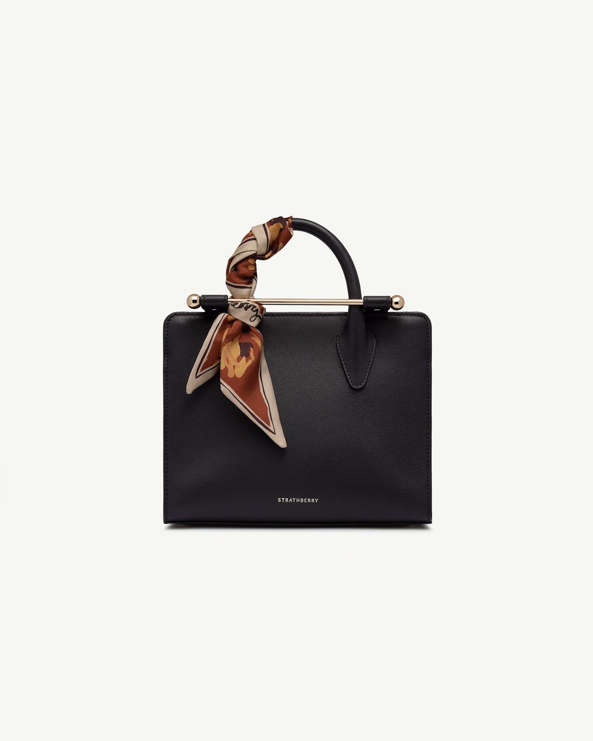 Sand and oxblood pop flowers silk skinny scarf tied to Strathberry handbag handle.