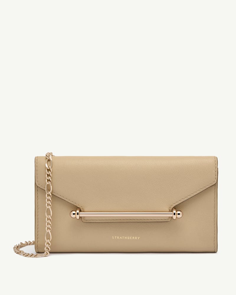 Strathberry chain wallet in sand with gold bar and chain.